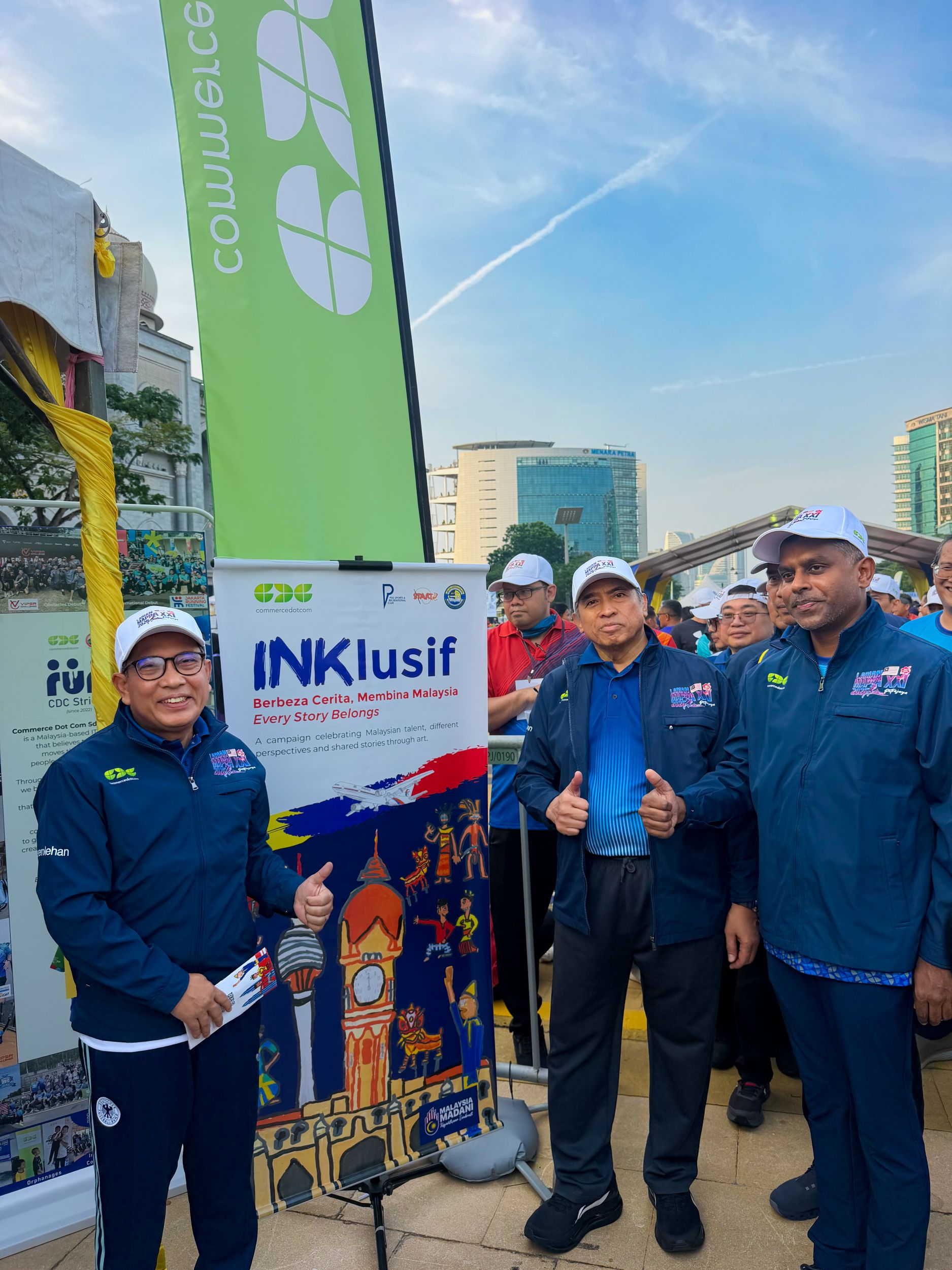 Larian MAPPA participants stand beside the INKlusif campaign display.
